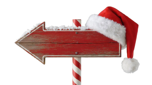 Rustic red wooden arrow signpost adorned with fluffy white snow and a festive santa hat pointing left isolated on transparent background - Powered by Adobe