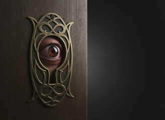 An eye peeking through a keyhole on a dark background for Halloween theme 