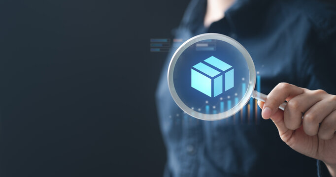 inventory, levels, stock, sku, Businessman analyzing inventory levels using digital technology with a magnifying glass icon and 3D box hologram, symbolizing stock control and warehouse management.
