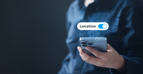 A person holding a smartphone with the location access switch turned on, representing data privacy settings, online security, and digital device protection for safe account management.