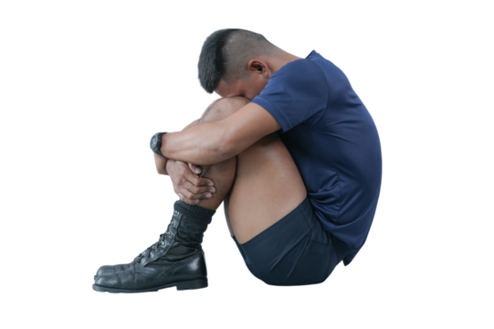 Man sitting on floor, hugging knees, wearing blue shirt, black shorts, and black boots, expressing sadness and loneliness, isolated on transparency background