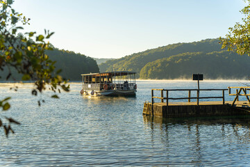 The electric boat for tourists on the Lake Kozjak, one of the Plitvice Lakes, on a sunny, autumn day. 