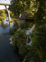 A long exposure photo of a picturesque waterfall in Rastoke, Croatia, famous for its many water cascades and mills.