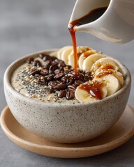 Coffee and Banana Smoothie Bowl with Sauce Pouring Over It