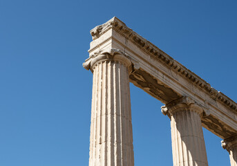 Majestic Ancient Greek Columns Under a Clear Vibrant Blue Sky