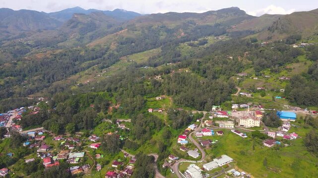 Aerial views of Aileu Municipality, Timor-Leste. Showing both concentrated settlements around the market and houses scattered across the vast, green mountain landscape.