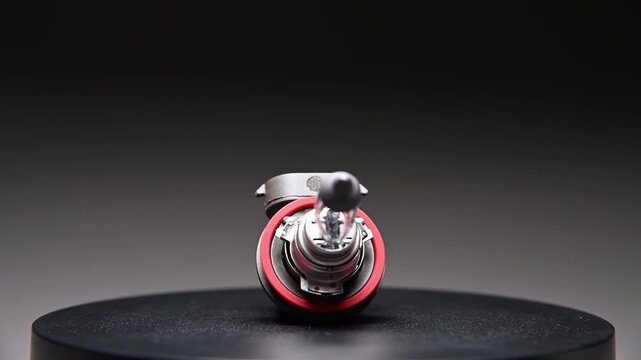 A new spare part rotates on a black gradient background. A car light bulb.
