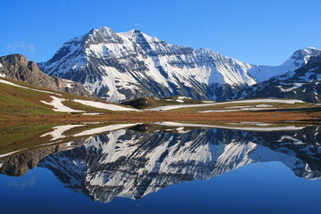 Amazing reflections in lake Plan du Lac Bellecombe looking towards La Grande Casse in the French alps