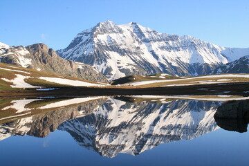 Amazing reflections in lake Plan du Lac Bellecombe looking towards La Grande Casse in the French alps