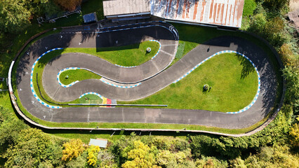 Aerial View of a Miniature RC Car Racing Track Surrounded by Greenery
