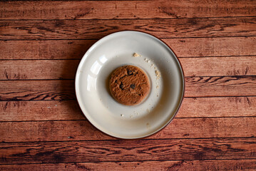 oatmeal cookies on a white saucer on a wooden table