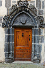 Old wooden door in a medieval village in Auvergne, France