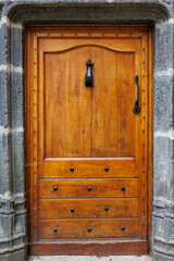 Old wooden door in a medieval village in Auvergne, France