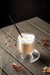 Hot latte coffee in glass cup with milk foam