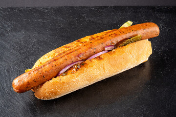 Grilled sausage hot dog with pickles and onion