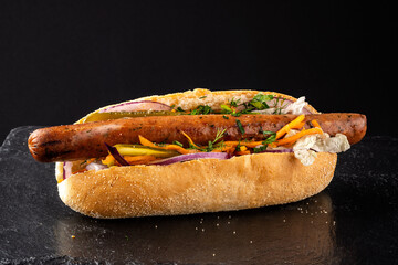 Grilled sausage hot dog with vegetables and herbs