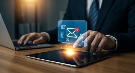 Email marketing concept. Professional using a laptop and holographic screen on a tablet to manage his inbox and customer communication