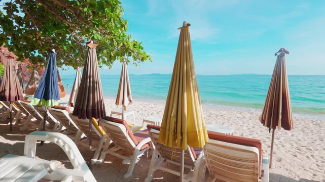 Empty beach chair on white sand beach windy sunset sky summer vacation background