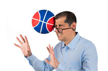 Businessman with blue shirt playing sport being hit by a basket ball with force in the face when he...