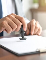 Office worker stamping a document with a rubber stamp, Ensuring document approval through rubber stamping on paper