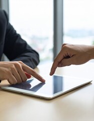 Collaborative Touch: Two Business Professionals Interacting with a Digital Tablet, Hands Sharing Ideas on a Sleek Touchscreen Device in a Modern Office Setting