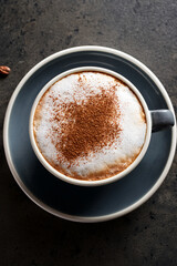 Close-up of foamy cappuccino in clear cup inspiring educational interest in coffee craftsmanship and promoting cultural heritage through beverages
