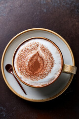 Close-up of creamy cappuccino in clear cup inspiring educational interest in coffee art and promoting sustainable living through mindful consumption
