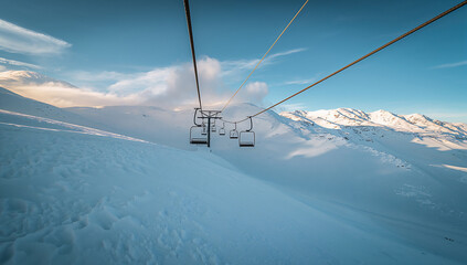 Serene Ski Lift Over Snowy Mountain Landscape at Sunset