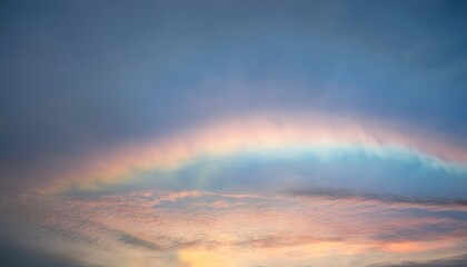 Bright blue sky with iridescent altocumulus clouds showing subtle rainbow colors
