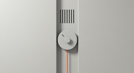 Minimalist gray wall detail with a circular dial, orange cable, and ventilation slots