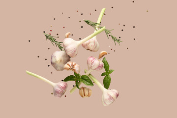 Flying fresh garlic with basil leaves, peppercorns and rosemary on brown background © Pixel-Shot