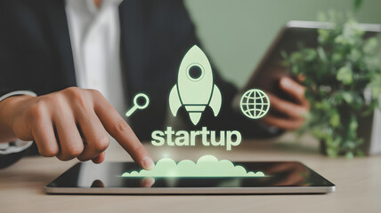 Person launching new business venture using digital tablet with rocket and global icons signifying startup success