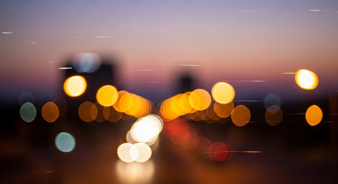 Dramatic city lights shimmer during twilight, creating a captivating bokeh effect perfect for backgrounds or abstract designs with a warm urban vibe