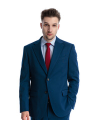 handsome young man in navy blue suit holding hand in pocket