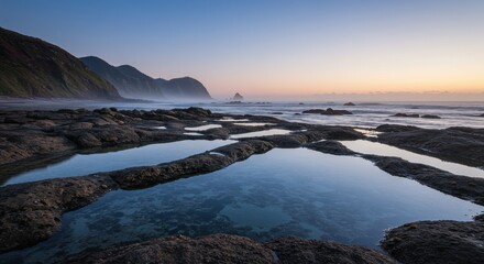 Serene Coastal Twilight - Reflecting Tidal Pools, Misty Ocean, and Distant Headland.
