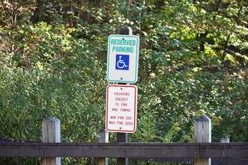 Handicap reserved parking violators no parking sign