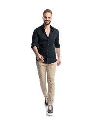 Fototapeta premium happy casual man with glasses looking forward and walking