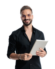 handsome casual guy with glasses holding tablet and smiling