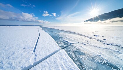 Fototapeta premium Blue ice and cracks on the surface of the ice. Frozen lake under a blue sky in the winter