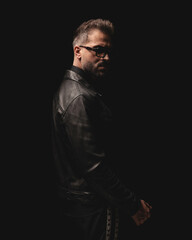attractive dramatic man with sunglasses standing and looking forward