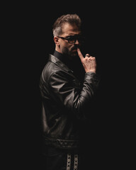 sexy sensual man with sunglasses touching lips and making silence gesture