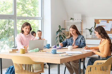 Group of students studying at table in classroom