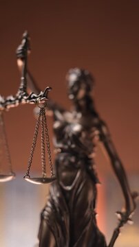 bronze blindfolded goddess representing law statue holding a scale and sword symbolizing impartiality and two broad sources of law 