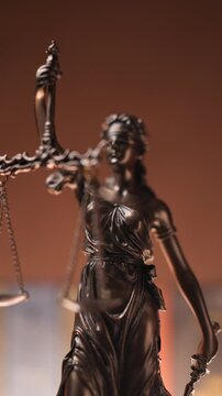 project video of justice statue represented by blindfolded woman holding a sword and a balance