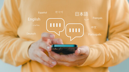 Person using smartphone with multilingual chat icons, representing global communication, language...
