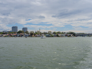 Obraz premium 11 October 2025 Residential Houses and apartment and commercial buildings on Parramatta River Sydney Harbour on a warm spring cloudy overcast day in Sydney NSW Australia