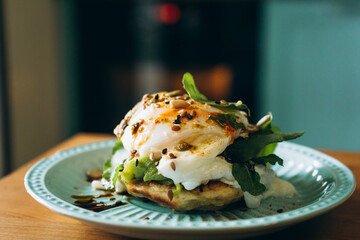 Poached eggs with spinach and seeds on rustic plate for healthy breakfast  