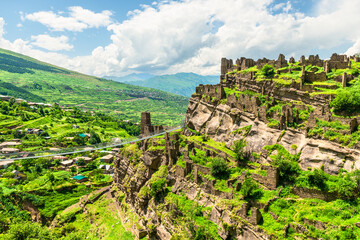 Ruins of the old village of Kakhib on a green mountain slope. North Caucasus © kosmos111