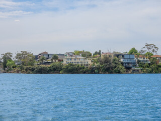 11 October 2025 Residential Houses and apartment buildings on Parramatta River Sydney Harbour on a warm spring cloudy overcast day in Sydney NSW Australia