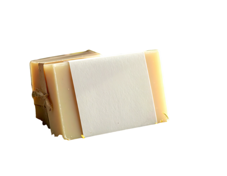 A close-up of a rectangular soap bar, wrapped with a label and twine against a black background